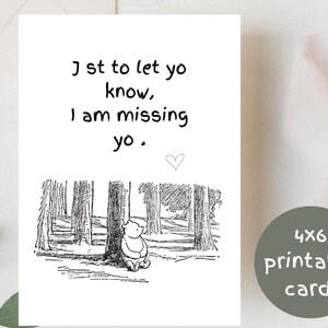 May include: A 4x6 printable card with the text "Just to let you know, I am missing you." The card features a black and white illustration of a bear sitting in a forest. A small heart is drawn below the text.