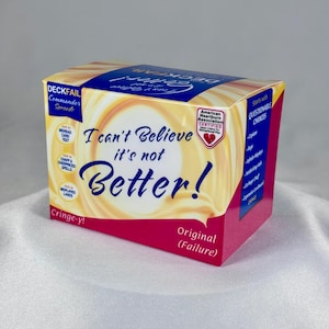 May include: A rectangular product box with a cream-colored swirl background and dark blue text reading I can't Believe it's not Better!. The box features a pink bottom panel, a blue side panel with the text Starts with QUESTIONABLE CHOICES, and a red heart logo.