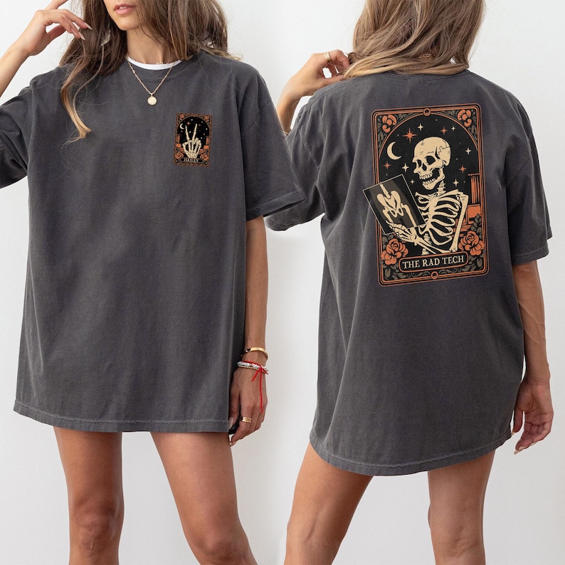 Close-up of the skeleton radiology shirt showing intricate Halloween artwork with stars, flowers, and a glowing skeleton hand forming a peace sign. Ideal for X-ray techs or radiologists who want to celebrate spooky season while showing pride in their profession.