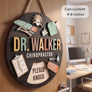 May include: A round wooden door sign with a dark wood grain finish featuring the text DR. WALKER CHIROPRACTOR and PLEASE KNOCK. It includes 3D cutouts of a chiropractic table, spine, scrub top, reflex hammer, and foam roller in muted colors.