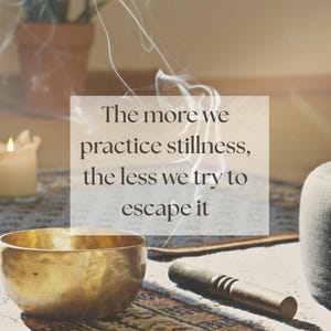 May include: A quote about stillness and escape: "The more we practice stillness, the less we try to escape it". The quote is displayed on a white background with a blurred image of a golden singing bowl, a wooden stick, and a candle in the background.
