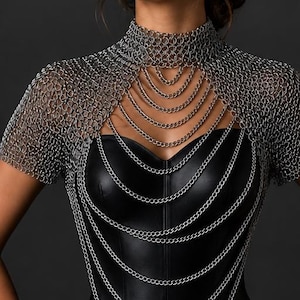 May include: A silver chainmail top with a high collar and short sleeves, worn over a black leather bodice. Multiple strands of chains cascade down the front. The words "FRONT VIEW" are visible at the bottom of the image.