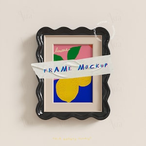 May include: A black wavy-edged frame with a colorful illustration of a lemon, green leaves, and the word "limone". The text "FRAME MOCKUP" is written across the frame with tape. The background is a light beige color.