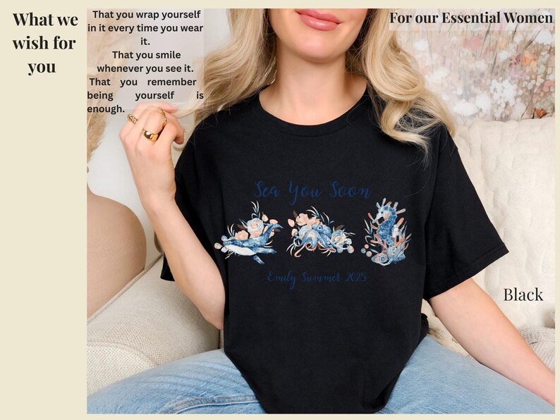 May include: A black short-sleeved t-shirt featuring a graphic print of a whale, an octopus, and a seahorse surrounded by floral elements. The text reads Sea You Soon and Emily Summer 2025. The shirt has a crew neckline and a standard fit design.
