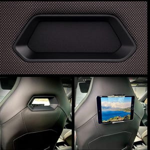 May include: Black car interior details. Top section shows a black, geometric-shaped storage tray. The bottom shows a black leather car seat with a tablet mounted on the back. The tablet displays a scenic view.