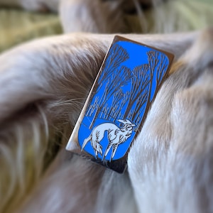 Winter Forest Spirit - polished silver-finished nickel metal filled with a gorgeous pale blue and white enamel silken windhound pin