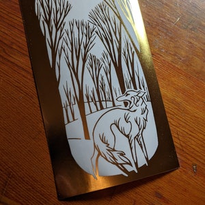 Forest Spirit - die cut gold vinyl sticker of a silken windhound in trees