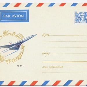 Pode incluir: Um envelope de correio aéreo vintage com uma borda listrada azul e vermelha. O envelope apresenta um desenho de um avião supersônico com o texto "PAR AVION" e "TY-144". Um selo postal com o texto "МИР ПОЧТА СССР 16 коп." está no canto superior direito.