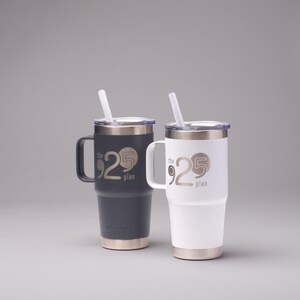 May include: Two stainless steel travel mugs with lids and straws. The mugs are black and white and have the text "the 925 plan" printed on them.