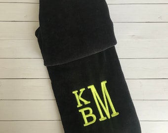 May include: Black golf towel with a green embroidered monogram "KM".
