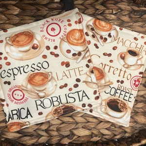 May include: A set of three ceramic mugs with a speckled, matte finish. The mugs are in shades of cream, light gray, and dark gray. Each mug has a simple, minimalist design and a rounded handle.