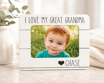 May include: A rectangular white wooden picture frame with horizontal plank detailing. The top features the black text I LOVE MY GREAT GRANDMA and the bottom displays a black heart icon followed by the name CHASE in black capital letters.