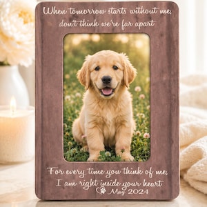 May include: A rectangular brown wooden picture frame featuring a photo of a golden puppy sitting in grass. The frame is engraved with the text: When tomorrow starts without me, don't think we're far apart. For every time you think of me, I am right inside your heart. May 2024.