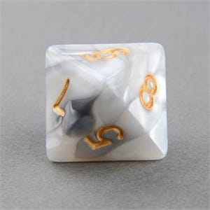 May include: A single, square, marbled dice with a gray and white pattern. The dice has gold-colored numbers 5, 7, and 8 on its faces. The dice is set against a plain, light gray background.