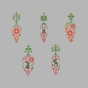 May include: A collection of five cross-stitch designs featuring carrot-shaped motifs. Each design includes red and yellow floral patterns, green foliage, and some include a brown bunny. The background is a light gray.