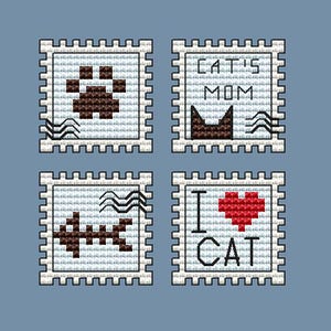 May include: Four square cross-stitch designs on a blue background. The designs include a paw print, a cat silhouette with the text "CAT'S MOM", a cross-stitch design, and a red heart with the text "I CAT".
