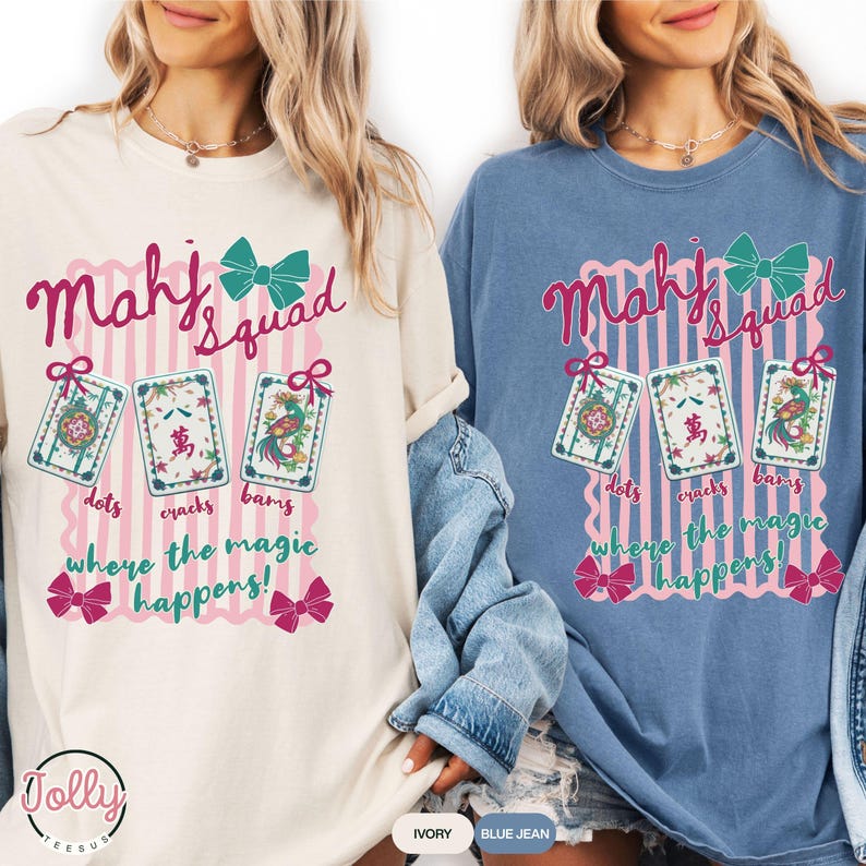 May include: Two long-sleeved shirts, one ivory and one blue jean, feature a graphic with the text "Mahj Squad" and "where the magic happens!". The design includes three Mahjong tiles and bows.