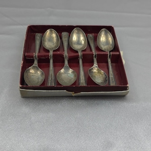 Silver-plated teaspoon set with tongs, floral pattern, in case.  Lots of engraving on spoons and case.