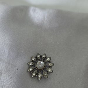 Vintage silver tone floral brooch with rhinestones