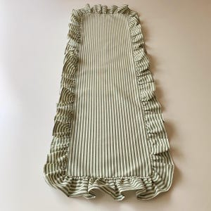 Farmhouse tablecloth runner draped across wooden table, adds rustic charm to kitchen and dining room settings.