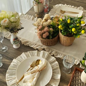 Styled round placemat with gold flatware showcasing farmhouse elegance, natural linen fabric complements modern and traditional decor