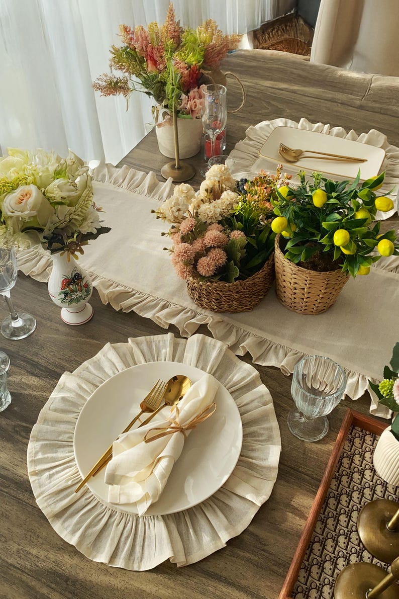 Styled round placemat with gold flatware showcasing farmhouse elegance, natural linen fabric complements modern and traditional decor