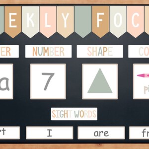 May include: A weekly focus chart with colourful flags at the top. The chart is divided into four sections: letter, number, shape, and colour. Each section has a corresponding image: the letter 'A', the number '7', a triangle, and a pink crayon. The bottom section of the chart features the words 'sight words' and four sight words: 'part', 'I', 'are', and 'from'.