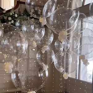 50 balões transparentes em formato de bolha com luzes LED, ideal para decoração de festas como casamentos, aniversários e chás de bebê.