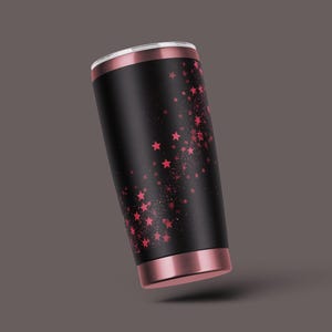 K&ouml;nnte beinhalten: Ein schwarzer und ros&eacute;goldener Becher mit einem rosa Sternenmuster.