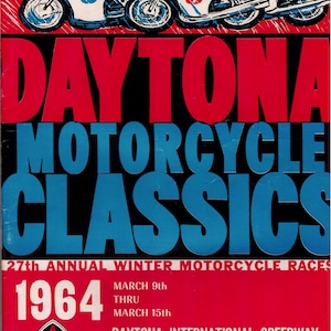 May include: Vintage poster for the 1964 Daytona Motorcycle Classics. The poster features three motorcycles racing, with the words "DAYTONA MOTORCYCLE CLASSICS" in large letters. Additional text includes the race dates and location.