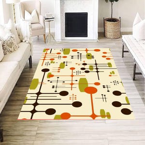 May include: A rectangular area rug featuring a cream-colored background with a repeating pattern of abstract geometric shapes in dark brown, bright orange, and olive green, including circles, elongated ovals, and thin intersecting lines.