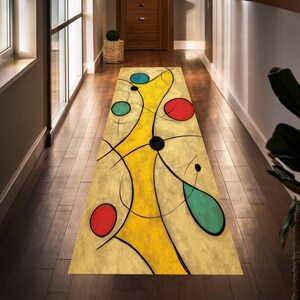 May include: A rectangular abstract art rug with a yellow central design, black lines, and red, blue, and teal circles. The rug is placed on a dark wood floor in a hallway, adding a pop of color and artistic flair to the space.