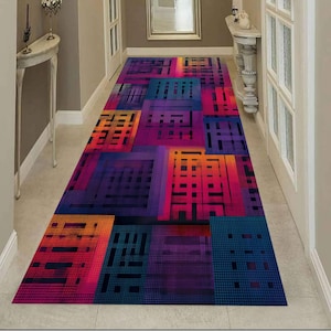 May include: A rectangular hallway runner rug with a vibrant geometric design. The rug features a repeating pattern of colourful blocks in shades of blue, purple, orange, and pink. The design creates a modern and eye-catching visual effect, suitable for home decor.