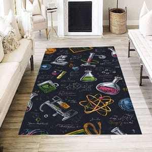 May include: A rectangular area rug with a dark background featuring a science theme. The rug displays various lab equipment illustrations, including beakers, test tubes, and a microscope, in white, green, pink, and yellow. The rug also has scientific formulas.