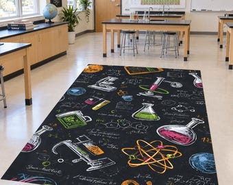 May include: A rectangular area rug featuring a black background with a white, green, pink, and orange chalk-style print of scientific equipment including microscopes, beakers, flasks, an atom model, and various chemical formulas and equations.