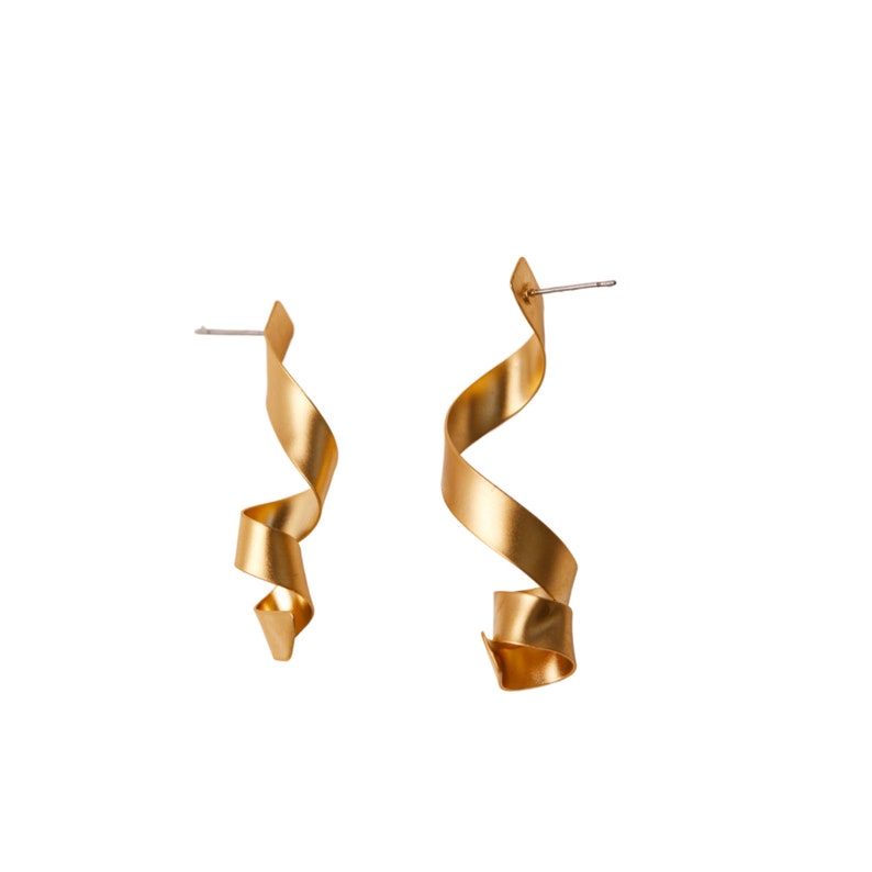 a pair of gold colored metal earrings
