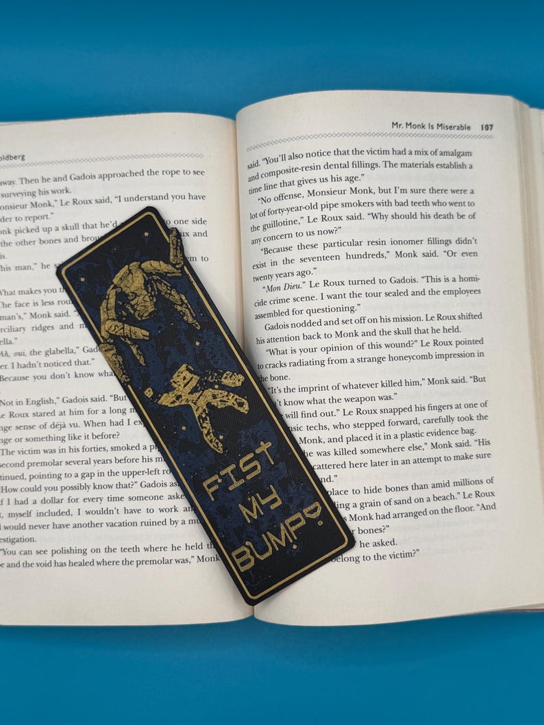 Rocky alien bookmark with a gold mechanical silhouette on black, sci-fi/gamer gift inspired by Project Hail Mary. FIST MY BUMP