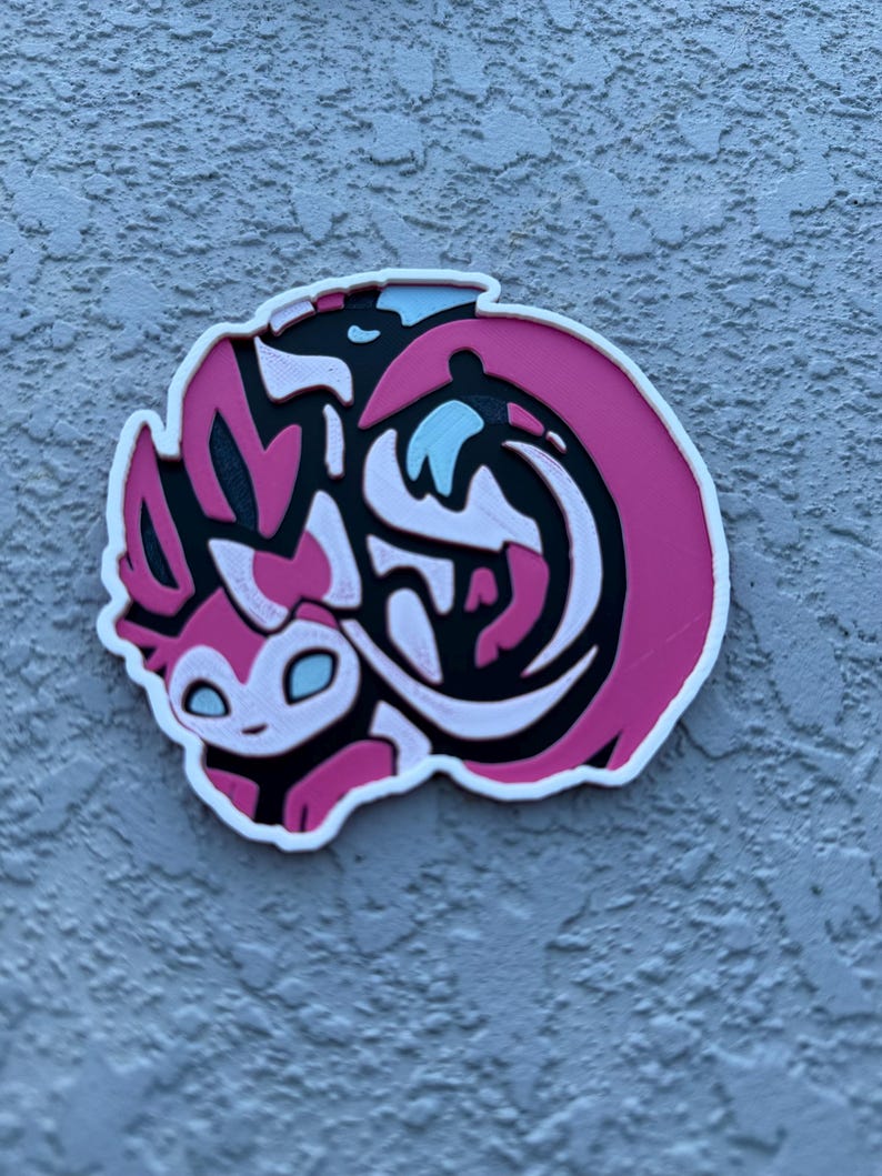 Round Eeveelution coaster Sylveon in cute Pokemon anime art.