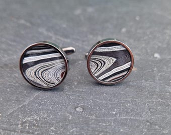 Cufflinks with fordite insert and epoxy resin coating