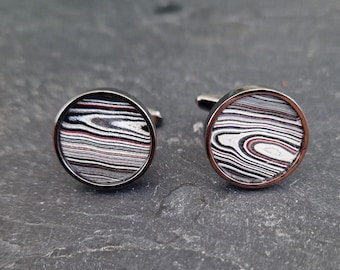 Cufflinks with fordite insert and epoxy resin coating