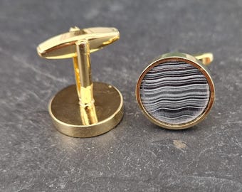 Cufflinks with fordite insert and epoxy resin coating
