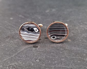 Cufflinks with fordite insert and epoxy resin coating