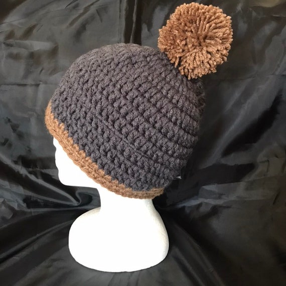 Three Cozy Knit Hats with Pom-poms, Each Featuring a Unique Color and