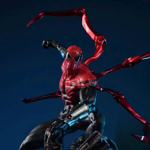 May include: A detailed figurine of Spider-Man in a dynamic pose, featuring a red and black suit with intricate textures. The figure has multiple red mechanical arms extending from its back, set against a dark blue backdrop.