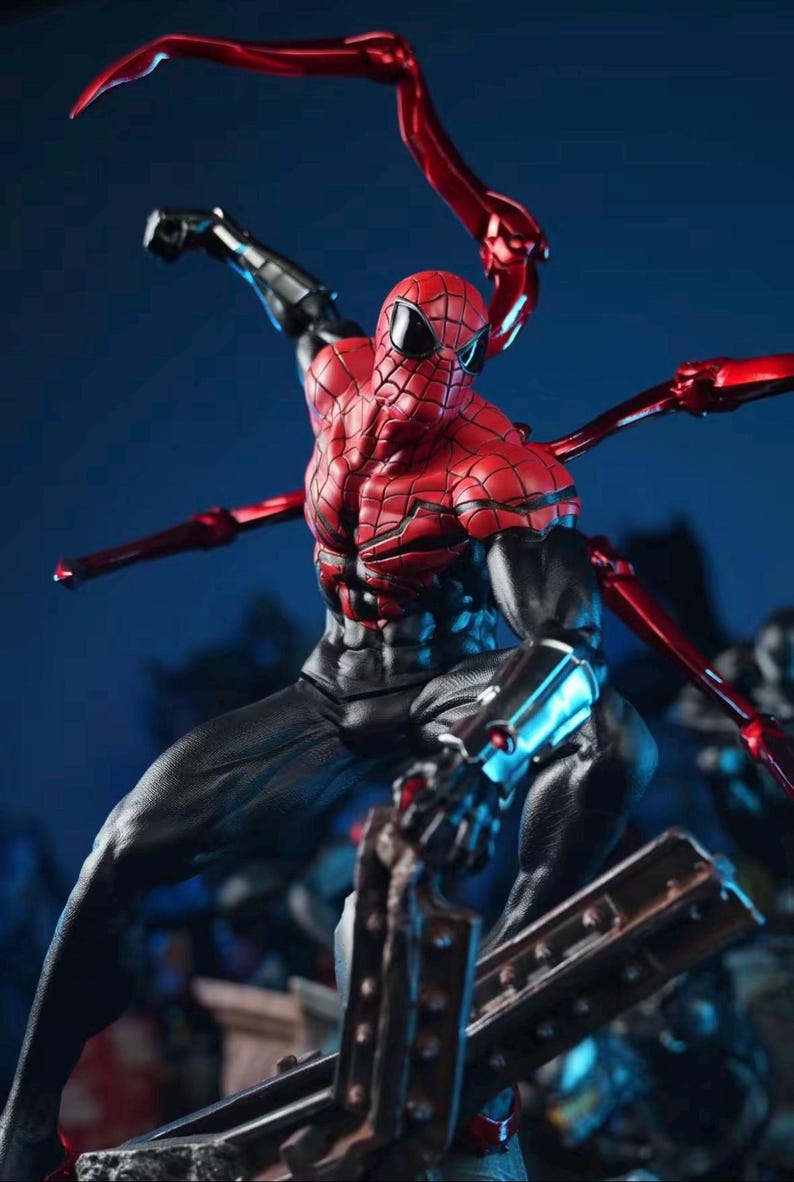 May include: A detailed action figure of Spider-Man in a dynamic pose. The figure features a red and black suit with intricate web detailing, and metallic red mechanical arms extending from the back. The figure is set against a dark blue background.