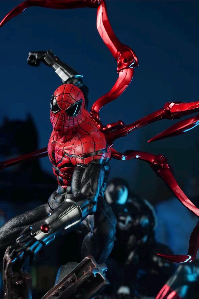 May include: A detailed action figure of a superhero in a dynamic pose. The figure features a red and black color scheme with metallic accents. The figure has multiple articulated limbs and a detailed mask. The background is a dark blue.