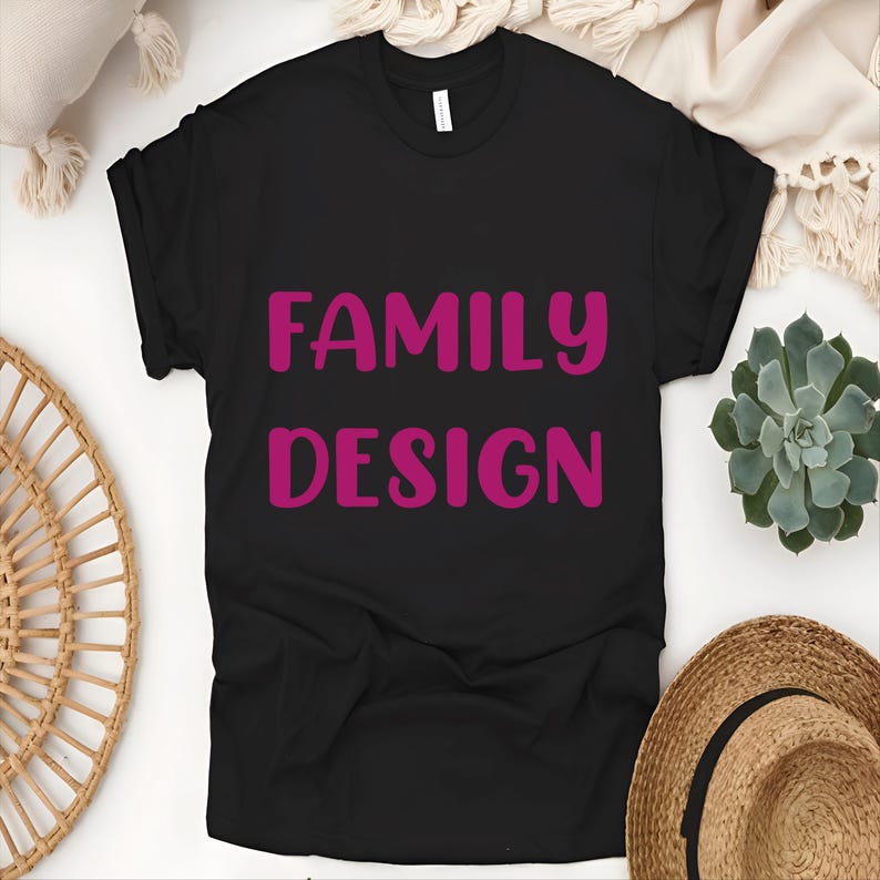 May include: Black t-shirt with the words "FAMILY DESIGN" in pink lettering.