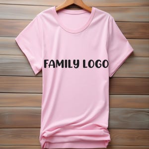 May include: A pink t-shirt with the text "FAMILY LOGO" printed in black on the front.