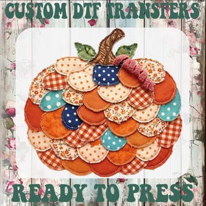 May include: A pumpkin-shaped graphic design composed of layered, circular fabric patches in orange, blue, and white with floral, polka dot, and gingham patterns. The text CUSTOM DTF TRANSFERS READY TO PRESS is printed in dark green at the top and bottom.