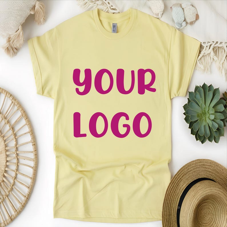May include: A yellow t-shirt with the text "YOUR LOGO" in pink lettering.